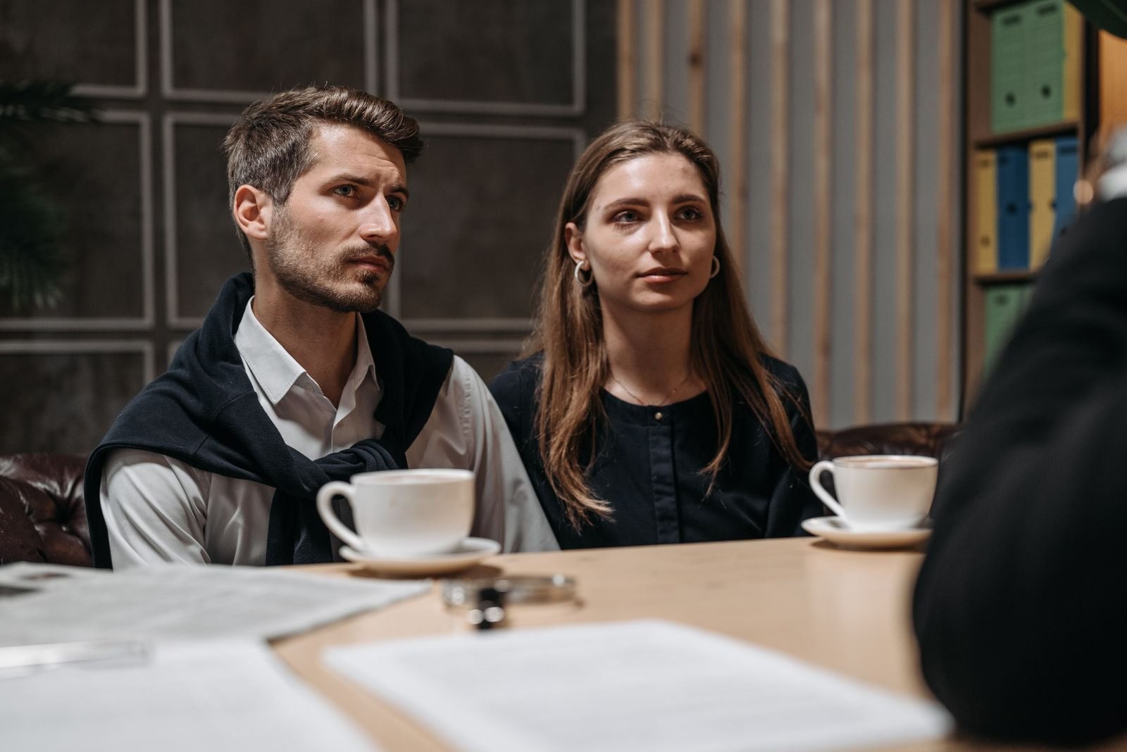 Adults reviewing documents during a consultation