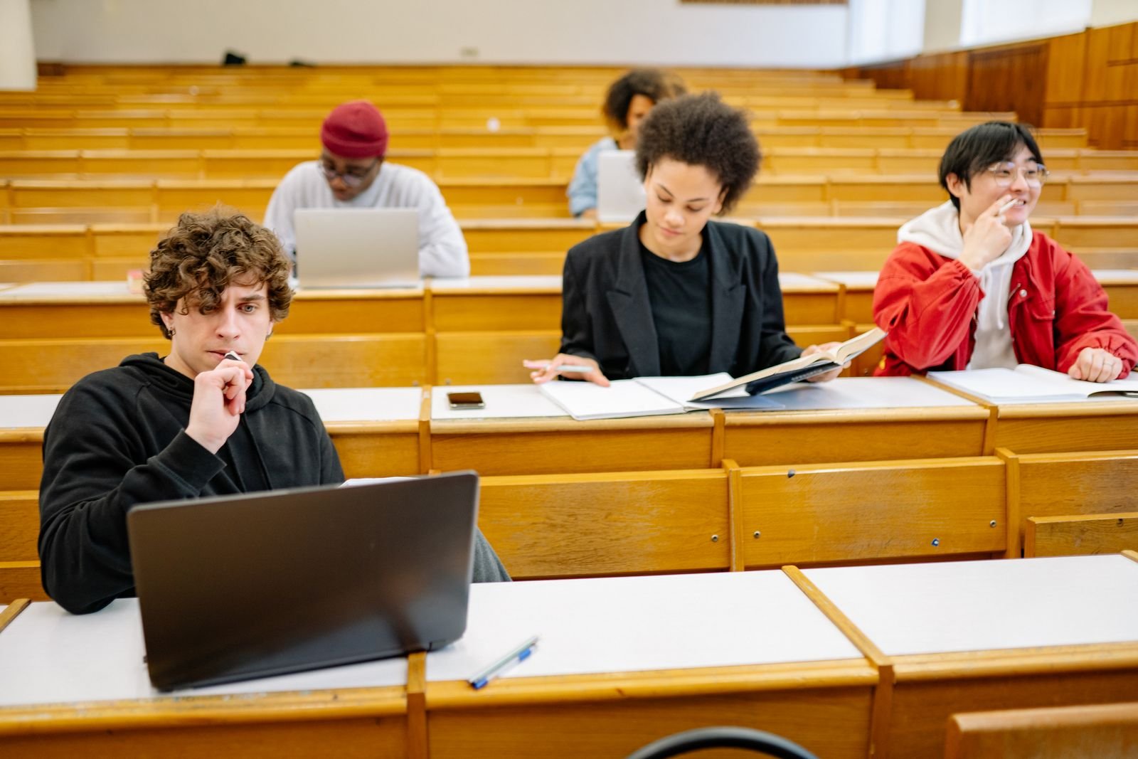 Students collaborating on a laptop at university